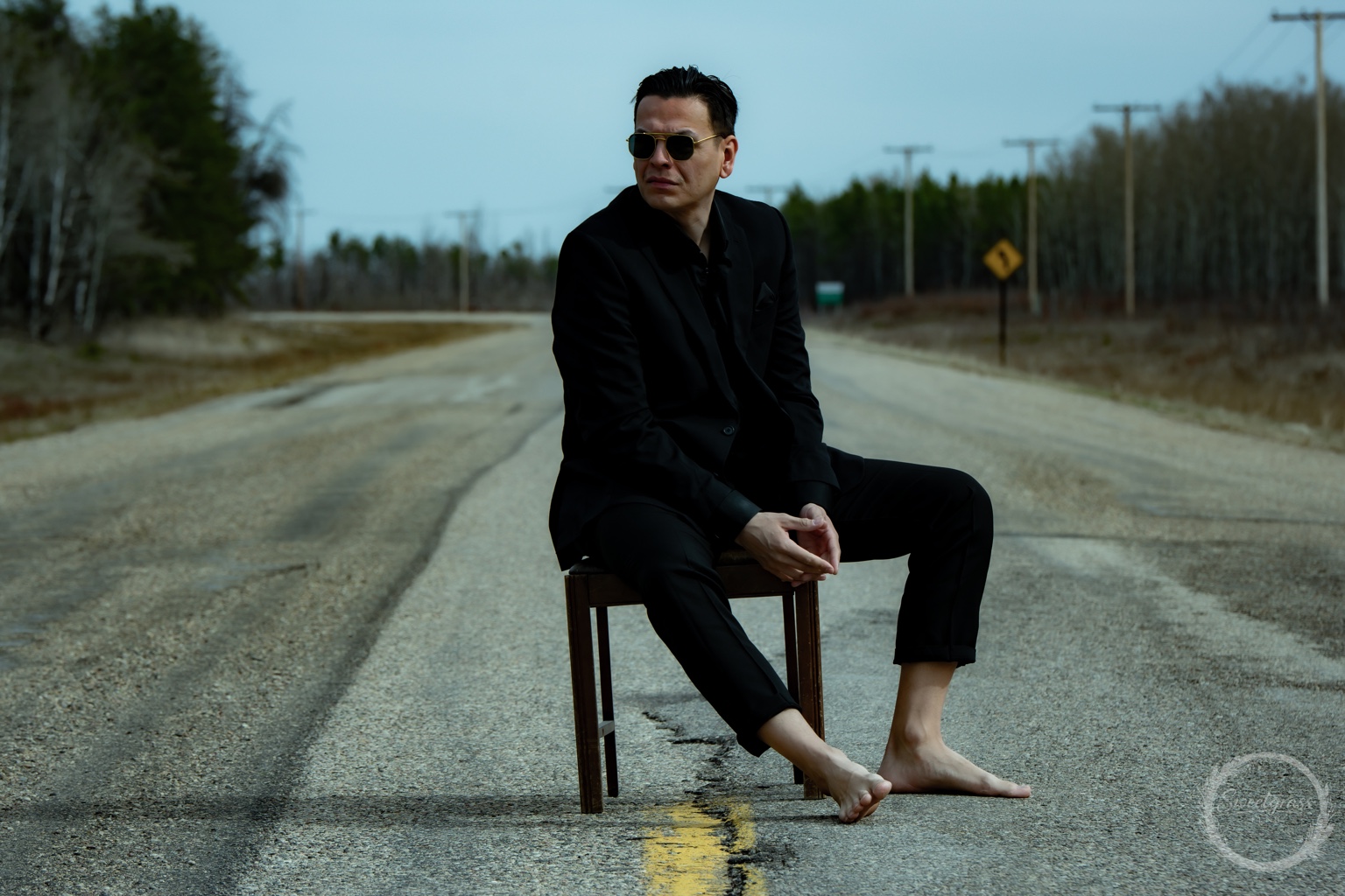 Dakota Favel seated outdoors on a rural road