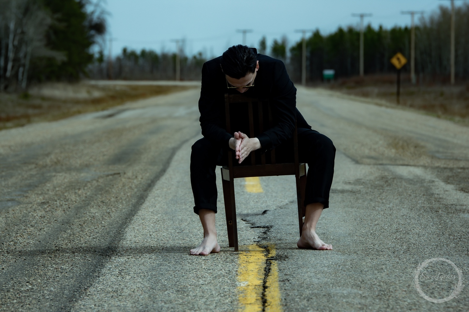 Dakota Favel leaning forward with his hands together in front of a chair