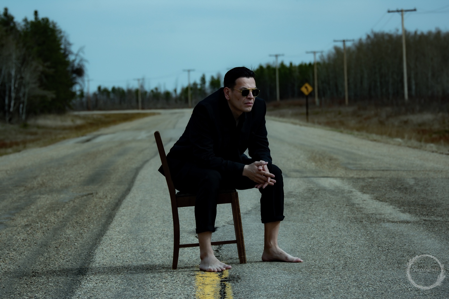 Dakota Favel sitting on a chair on a rural road